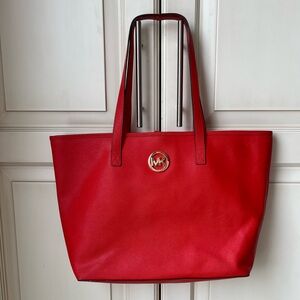 Michael Kohrs large “flame red” saffiano leather Jetsetter tote bag.
